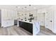 Modern kitchen with white cabinets, marble island, and gold accents at 9541 Summersweet Ct, Las Vegas, NV 89123