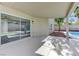 Covered patio with sliding glass doors and pool view at 9541 Summersweet Ct, Las Vegas, NV 89123