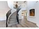 Modern curved staircase, gray steps and black railing at 9541 Summersweet Ct, Las Vegas, NV 89123