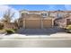 Two-story house with stone accents and a three-car garage at 3957 Little Creek Ave, Las Vegas, NV 89141