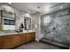 Luxurious bathroom with marble walls and double vanity at 10130 Sequoia Glen Ave, Las Vegas, NV 89166