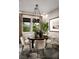 Elegant dining room with round table and neutral-toned chairs at 10130 Sequoia Glen Ave, Las Vegas, NV 89166
