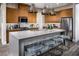 Modern kitchen with wood cabinets, gray island, and stainless steel appliances at 10130 Sequoia Glen Ave, Las Vegas, NV 89166