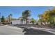 Single-story home with a three-car garage and mature landscaping at 1028 Norellat Rd, Henderson, NV 89011