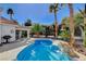 Sparkling pool with rock waterfall feature in backyard oasis at 1028 Norellat Rd, Henderson, NV 89011