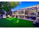 Landscaped backyard featuring a pergola, lounge area, and lush lawn at 1057 Daylight Blaze Way, Henderson, NV 89052