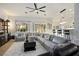 Spacious living room featuring a large sectional sofa, a modern coffee table, and stylish decor at 1057 Daylight Blaze Way, Henderson, NV 89052