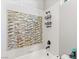 Clean bathroom with a bathtub and mosaic tile accent wall at 109 Aventura St, Las Vegas, NV 89144