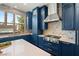 Modern kitchen with navy blue cabinets and stainless steel appliances at 109 Aventura St, Las Vegas, NV 89144