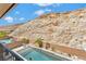 Elevated view of backyard oasis with glistening pool, mountain backdrop, and patio furniture at 12617 New Providence St, Las Vegas, NV 89141