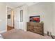 Spacious bedroom with dresser, TV, and access to hallway at 12617 New Providence St, Las Vegas, NV 89141