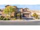 Two-story house with stone accents and a three-car garage at 12617 New Providence St, Las Vegas, NV 89141