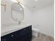 Modern bathroom with dark vanity and oval mirror at 1513 Irene Dr, Boulder City, NV 89005