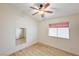 Bright bedroom featuring wood-look floors and ceiling fan at 1809 Derbyshire Dr, Las Vegas, NV 89117