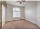 Simple bedroom with carpeted floor, large window, and mirrored closet at 2149 Eaglepath Cir, Henderson, NV 89074