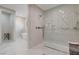 Spacious primary bathroom features a glass enclosed shower and free standing tub with modern fixtures at 3104 Conners Dr, Las Vegas, NV 89107