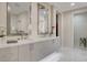 Bathroom boasts double sink vanity with modern fixtures, white marble floors and a glass enclosed shower at 3104 Conners Dr, Las Vegas, NV 89107