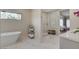 Bathroom boasts a free standing tub, glass enclosed shower, and double sink vanity with modern fixtures at 3104 Conners Dr, Las Vegas, NV 89107