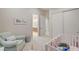 Inviting Bedroom featuring a crib, comfortable chair, and access to the bathroom at 3104 Conners Dr, Las Vegas, NV 89107