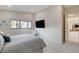 Sunlit bedroom with large windows, a TV, and a comfortable chair for relaxing at 3104 Conners Dr, Las Vegas, NV 89107