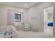 Lovely Bedroom with a crib, cozy chair, and light-filled window at 3104 Conners Dr, Las Vegas, NV 89107