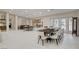 Bright and airy dining area with seating for eight, adjacent to open kitchen and living space at 3104 Conners Dr, Las Vegas, NV 89107