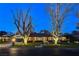 Attractive brick home with a landscaped lawn at dusk at 3104 Conners Dr, Las Vegas, NV 89107