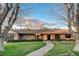 Inviting brick home featuring a well-manicured lawn, trimmed hedges, and a brick walkway to the entrance at 3104 Conners Dr, Las Vegas, NV 89107