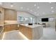 Bright, modern kitchen features custom wood cabinets and a large island with marble countertop and open layout at 3104 Conners Dr, Las Vegas, NV 89107