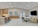 Open concept kitchen with island seating, tile floors, natural light, and backyard access at 3104 Conners Dr, Las Vegas, NV 89107
