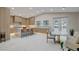 Modern kitchen with wood cabinets, island with seating, tile floor, and access to the backyard at 3104 Conners Dr, Las Vegas, NV 89107