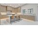 Bright kitchen featuring an island with seating, ample counter space, and modern lighting at 3104 Conners Dr, Las Vegas, NV 89107