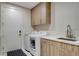Efficient laundry area with modern washer and dryer, alongside plenty of cabinet space at 3104 Conners Dr, Las Vegas, NV 89107
