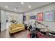 Spacious living room featuring a drum set, guitars, and a comfortable yellow sofa at 3104 Conners Dr, Las Vegas, NV 89107