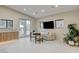 Well-lit living space features tile flooring, outdoor access, and modern decor at 3104 Conners Dr, Las Vegas, NV 89107