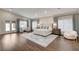 Bright main bedroom with hardwood floors, sitting area, and direct access to the backyard through French doors at 3104 Conners Dr, Las Vegas, NV 89107
