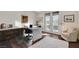 Home office featuring a large desk area, custom cabinets, and French doors providing access to the outside at 3104 Conners Dr, Las Vegas, NV 89107