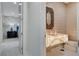 Stunning powder room with an illuminated marble sink and unique decorative mirror at 3104 Conners Dr, Las Vegas, NV 89107