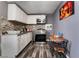 Small kitchen with white cabinets and mosaic backsplash at 3240 Seneca Dr, Las Vegas, NV 89169