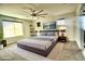 Main bedroom with a large bed, ceiling fan, and plenty of natural light at 3439 Midnight Shadows Way, North Las Vegas, NV 89032