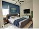 Gray bedroom with a large bed and a wall-mounted TV at 3439 Midnight Shadows Way, North Las Vegas, NV 89032
