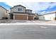 Two-story house with brown garage doors and a paved driveway at 3439 Midnight Shadows Way, North Las Vegas, NV 89032