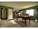 Home office with a large desk, bookcase, and leather chair at 3439 Midnight Shadows Way, North Las Vegas, NV 89032