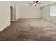 Spacious bedroom with ceiling fan and neutral carpeting at 347 S Milan St, Henderson, NV 89015