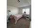 Light-filled bedroom with soft pink accents and shuttered windows, creating a relaxing atmosphere at 4466 Palm Grove Dr, Las Vegas, NV 89120