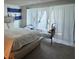 Bright bedroom features neutral tones, large windows and an El Salvador flag at 4466 Palm Grove Dr, Las Vegas, NV 89120