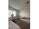 Bright bedroom featuring shuttered windows and a cozy daybed, perfect for relaxation at 4466 Palm Grove Dr, Las Vegas, NV 89120