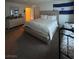 Spacious bedroom features neutral tones, a king bed and an El Salvador flag at 4466 Palm Grove Dr, Las Vegas, NV 89120