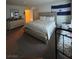 Spacious bedroom features neutral tones, a king bed and an El Salvador flag at 4466 Palm Grove Dr, Las Vegas, NV 89120
