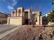 Charming two-story home features desert landscaping, Spanish-tile roof and a two-car garage at 4466 Palm Grove Dr, Las Vegas, NV 89120